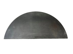 Half-circle metal object on a textured surface