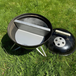 Weber Smokey Joe fitted with an offset plate and basket