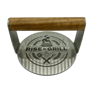 Stainless burger smasher with Rise And Grill logo and wooden handle