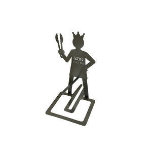 Metallic figure of a 'BBQ Legend' holding tongs on a white background
