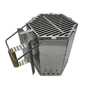 Angled view of CLD Fabrication charcoal chimney with optional top cooking grill, timber grip, heat shield and assist handle.