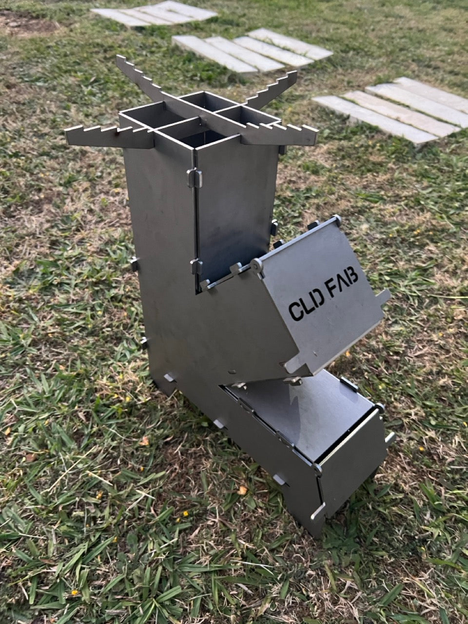 CLD Fabrication BBQ and camping accessories including charcoal chimneys, burger smashers, flat pack grills and live fire cooking gear