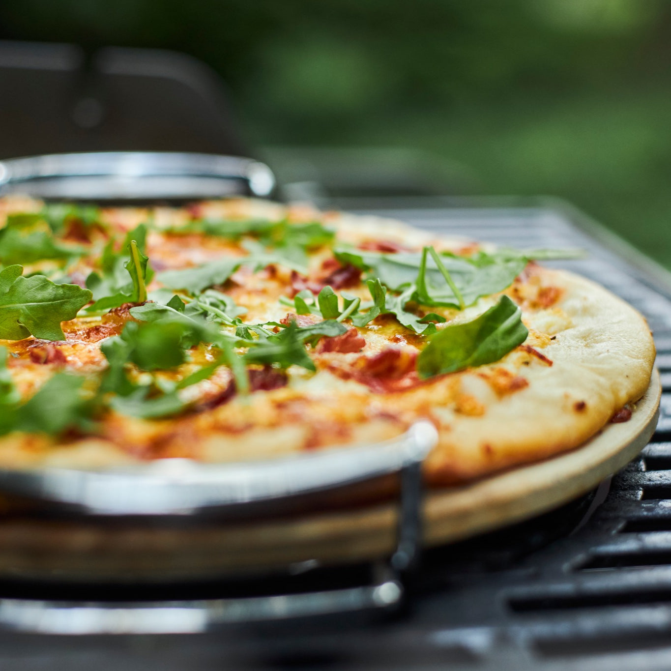 Wood-fired style pizza cooked on a kettle BBQ using CLD Fabrication pizza steel and stone holder accessories