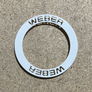 Weber wheel insert sitting on a bench unfitted