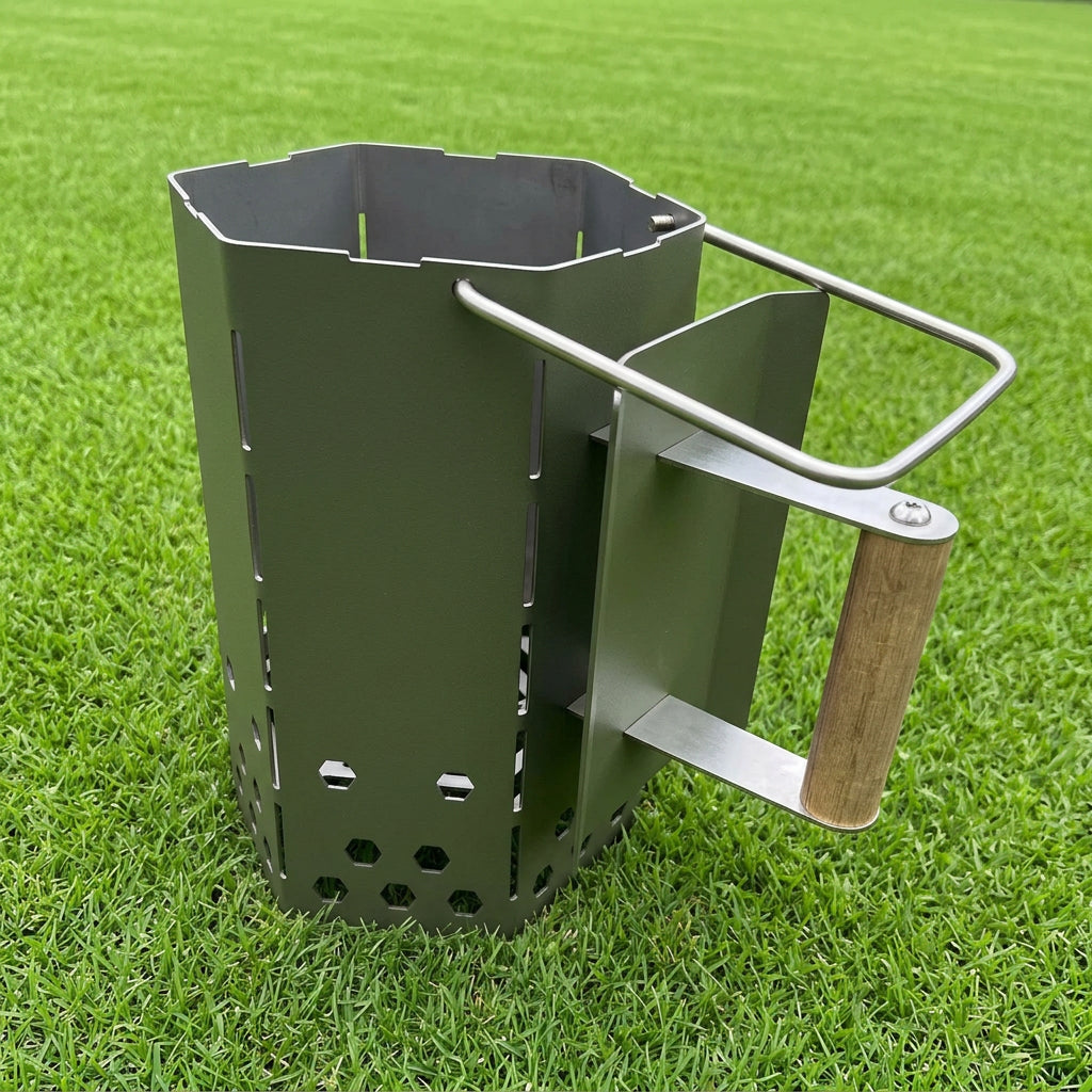 Metal fire starter tool with wooden handle on grass