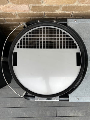 Stainless grill griddle plate fitted to a weber kettle top view