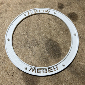 Backside of a wheel insert showing the raised edges sitting on a bench