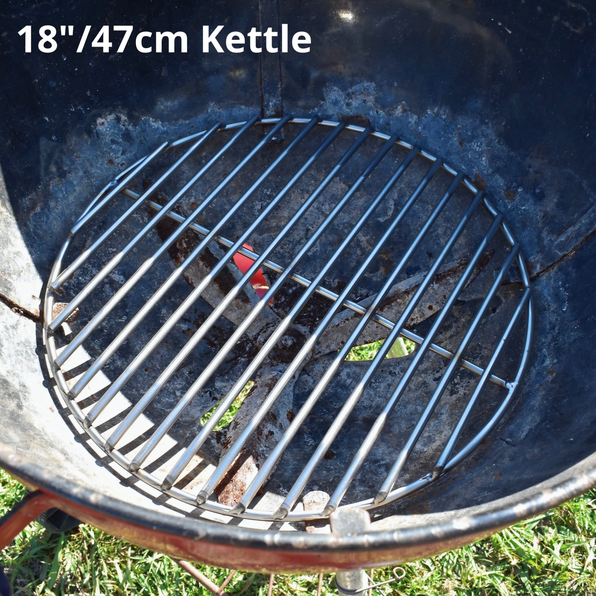 47cm charcoal grate fitted to a red weber kettle grass background