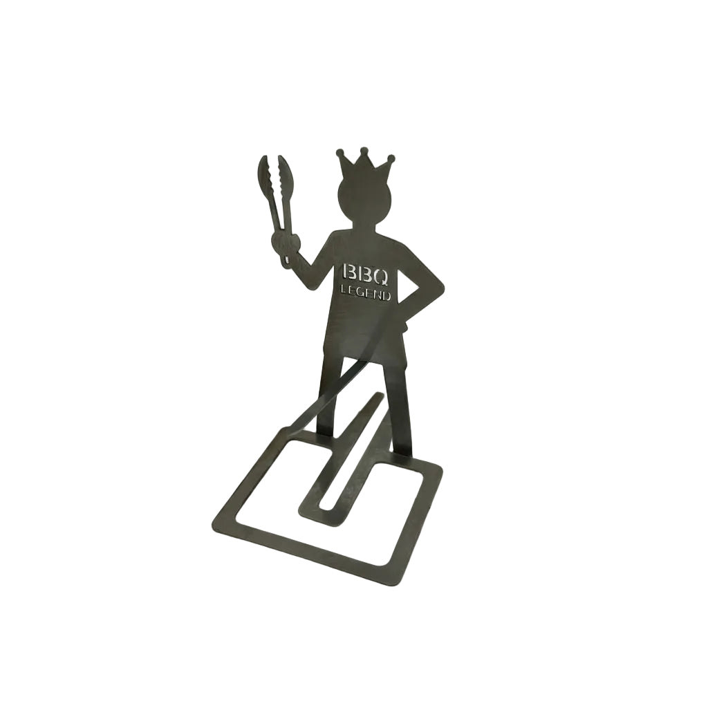Metallic figure of a 'BBQ Legend' holding tongs on a white background