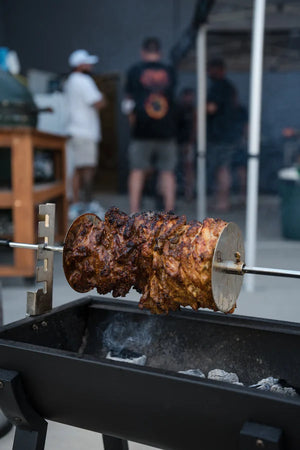 Pitmaster demonstrating fire management and charcoal setup at a hands-on BBQ class