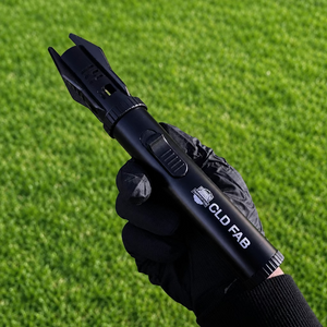 Black CLD FAB Jet Firelighter held in a gloved hand, showing the ignition switch and protective tip.